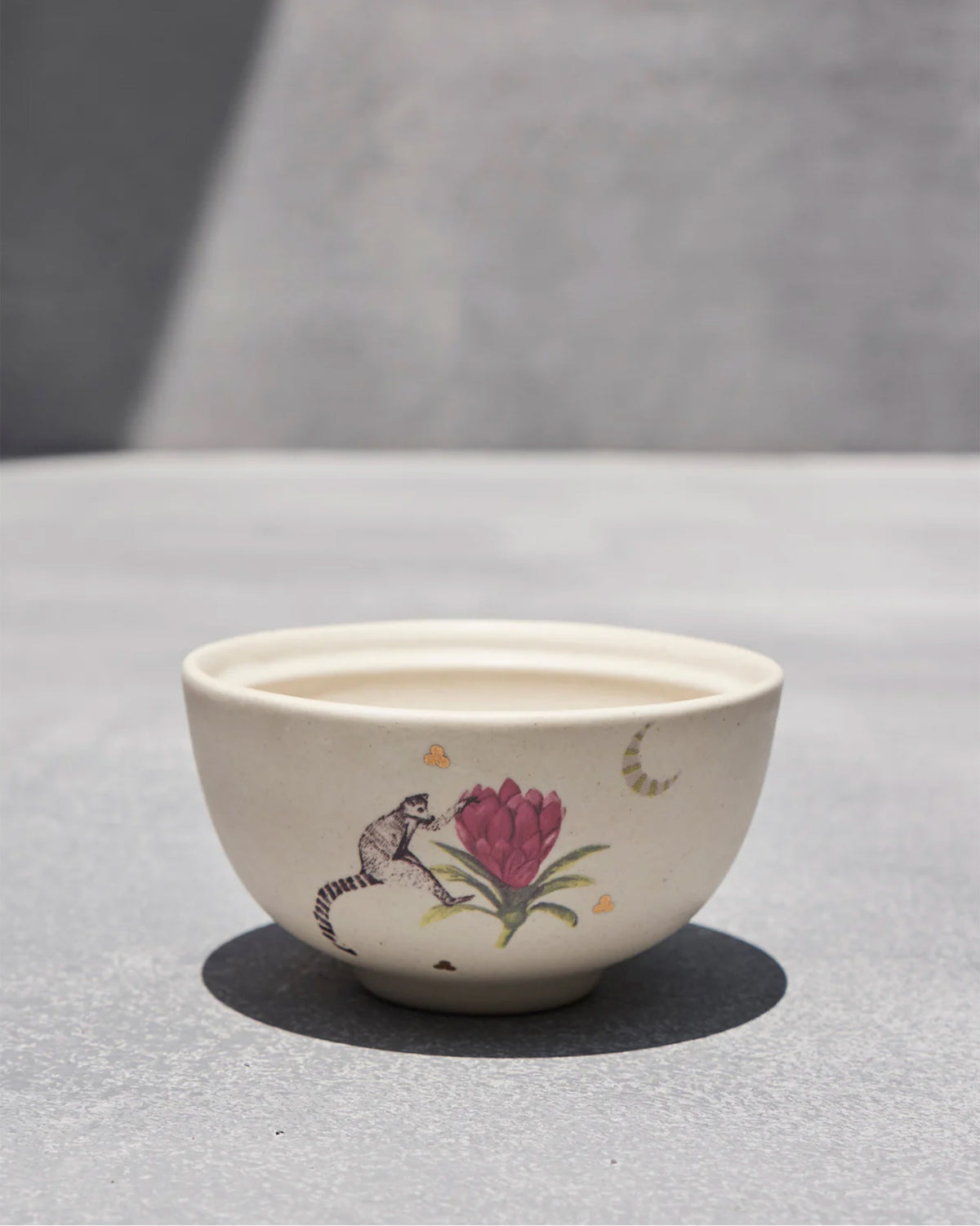 Cream Madagascar katori with a lemur and pink tropical flower.
