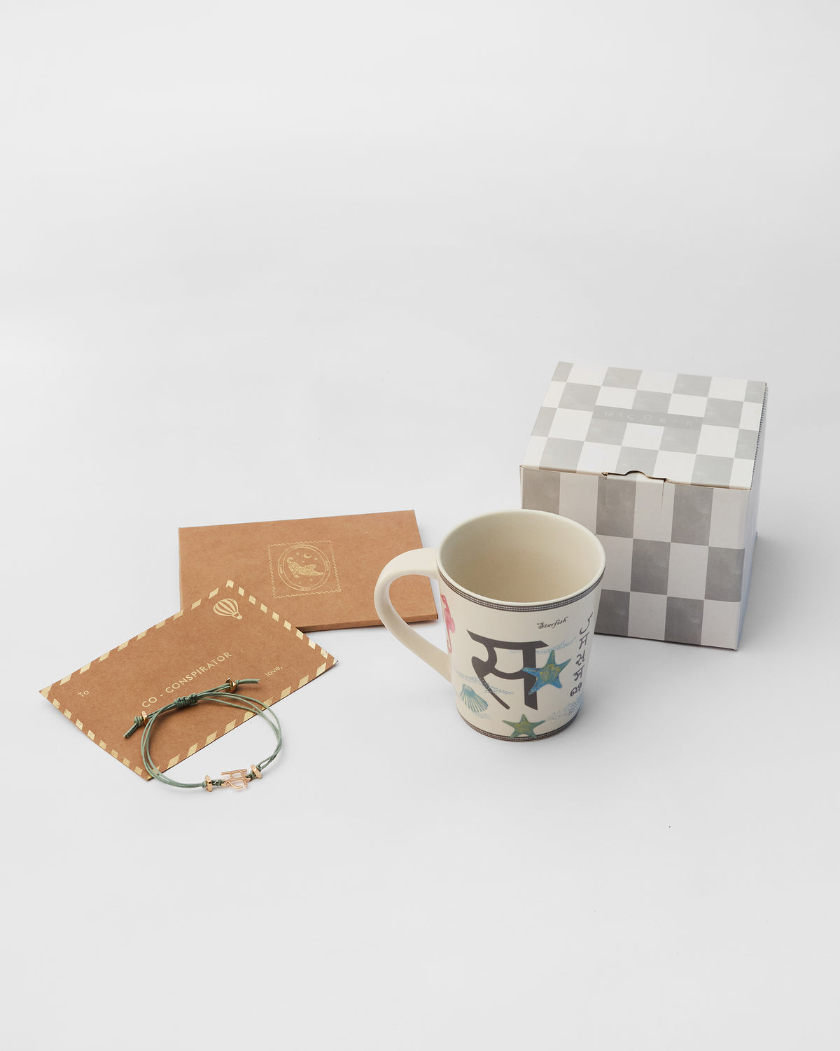 Singha rakhi set with letter S mug, rakhi, and gift box.