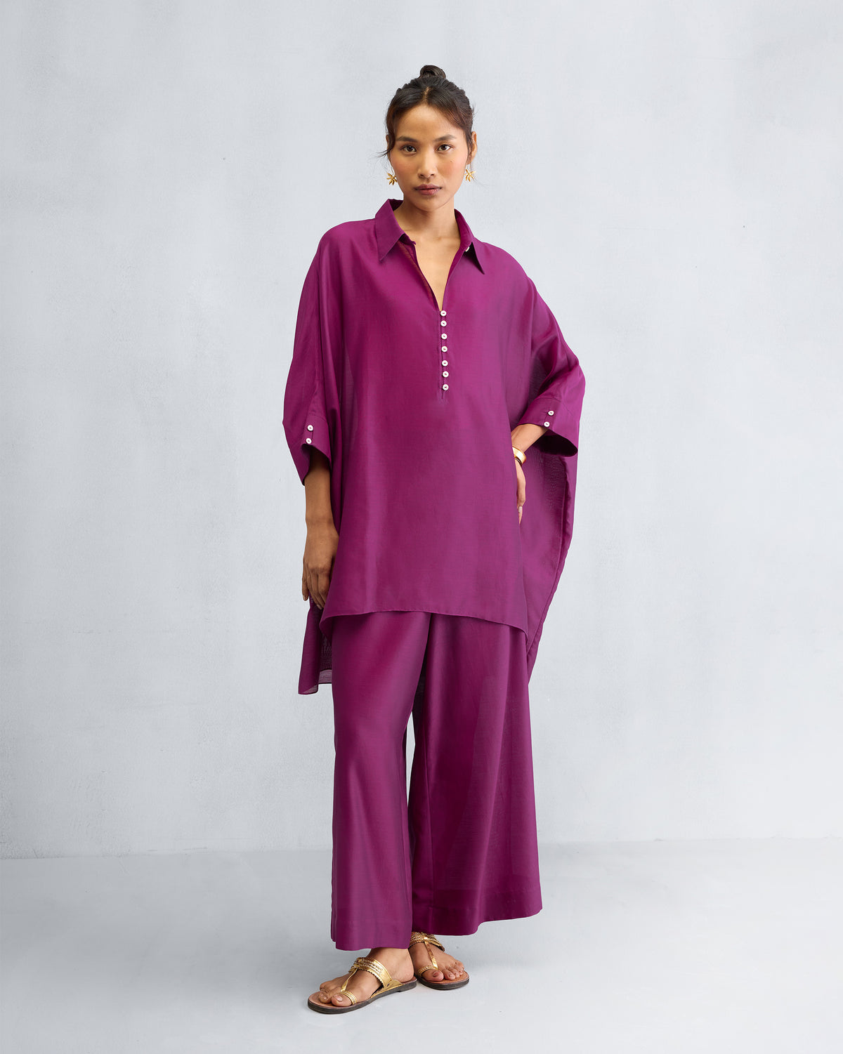 Person wearing a mulberry Hala tunic set with matching trousers.