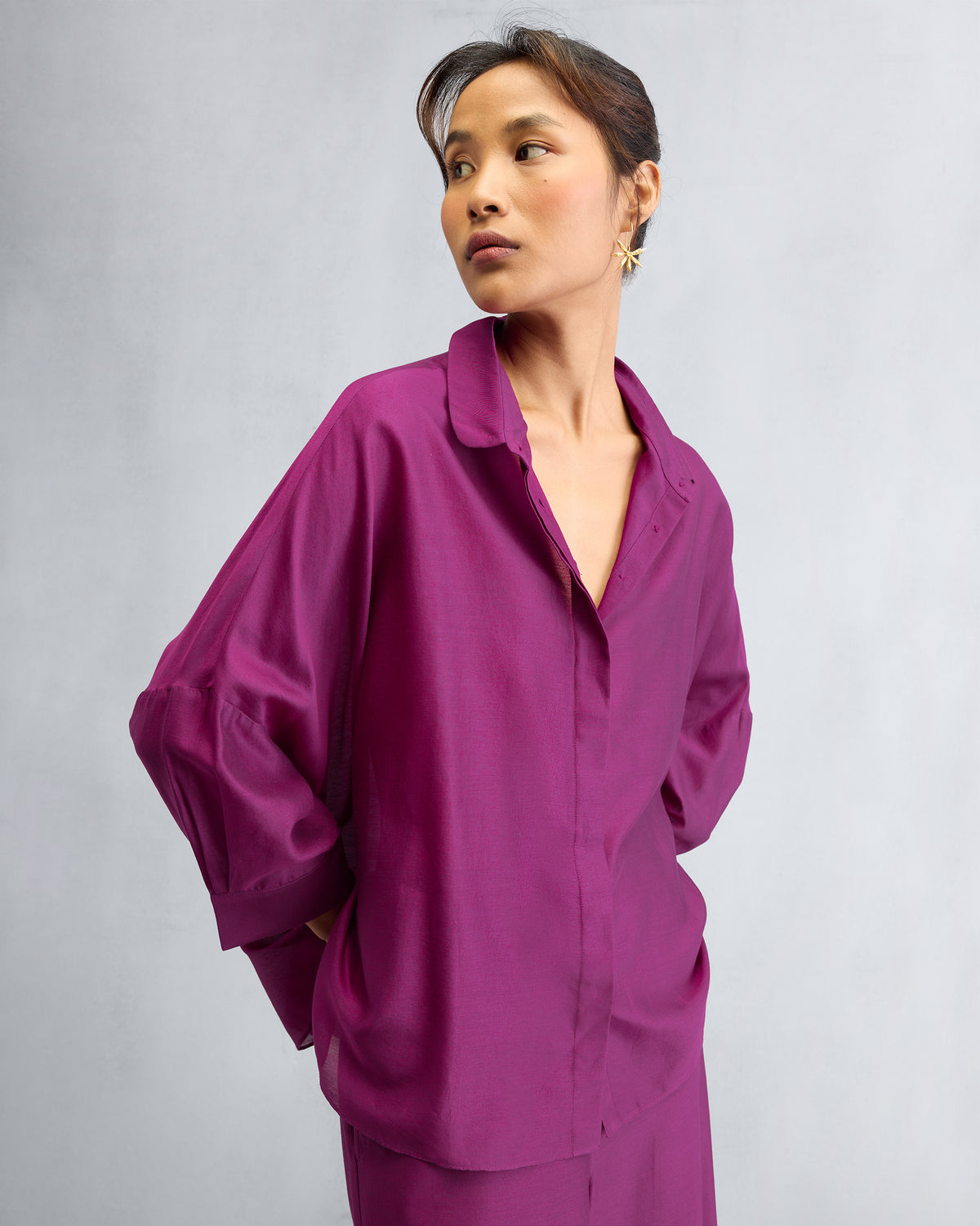 Mulberry boxy shirt with dropped shoulders and wide sleeves worn as a set.