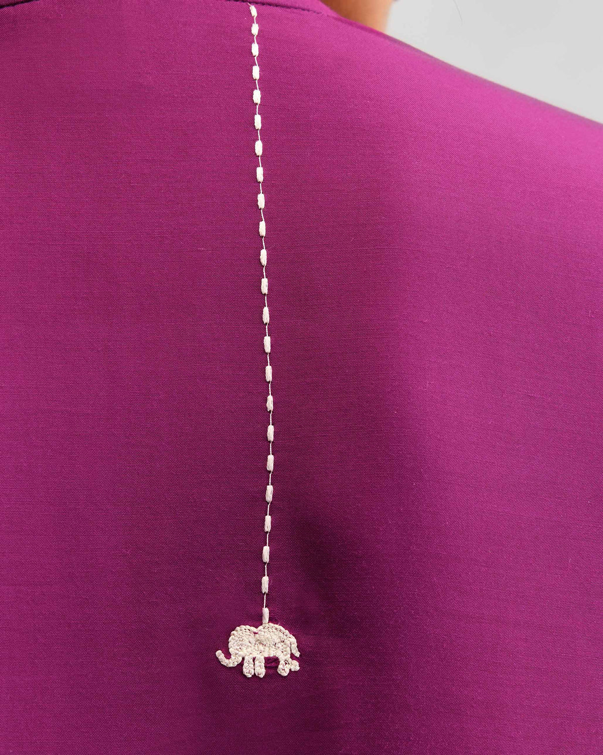 Close-up of silver elephant embroidery on the back of a mulberry kurta.