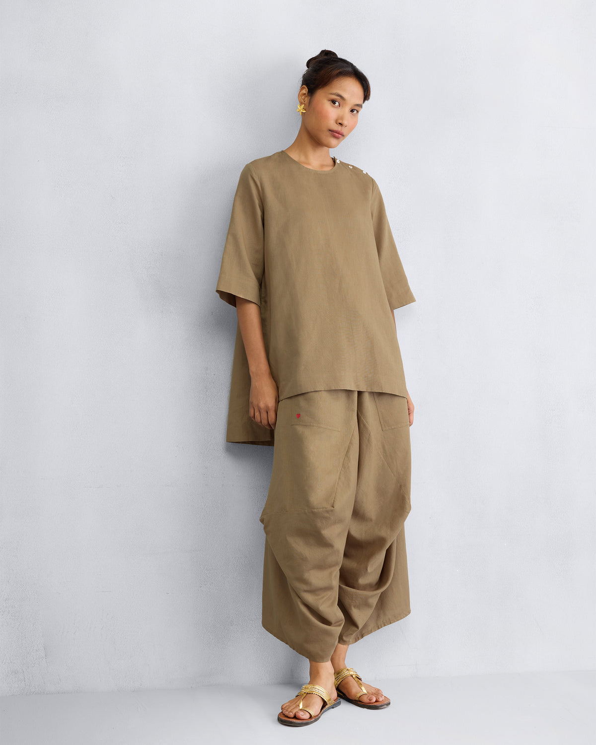 Person wearing the High Slit Top Set with gathered, wide-cut pants.