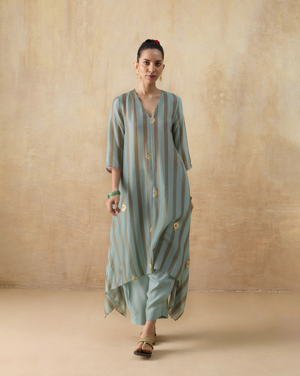 Person wearing a striped Midnight Club Kurta Set with gold foil motifs.