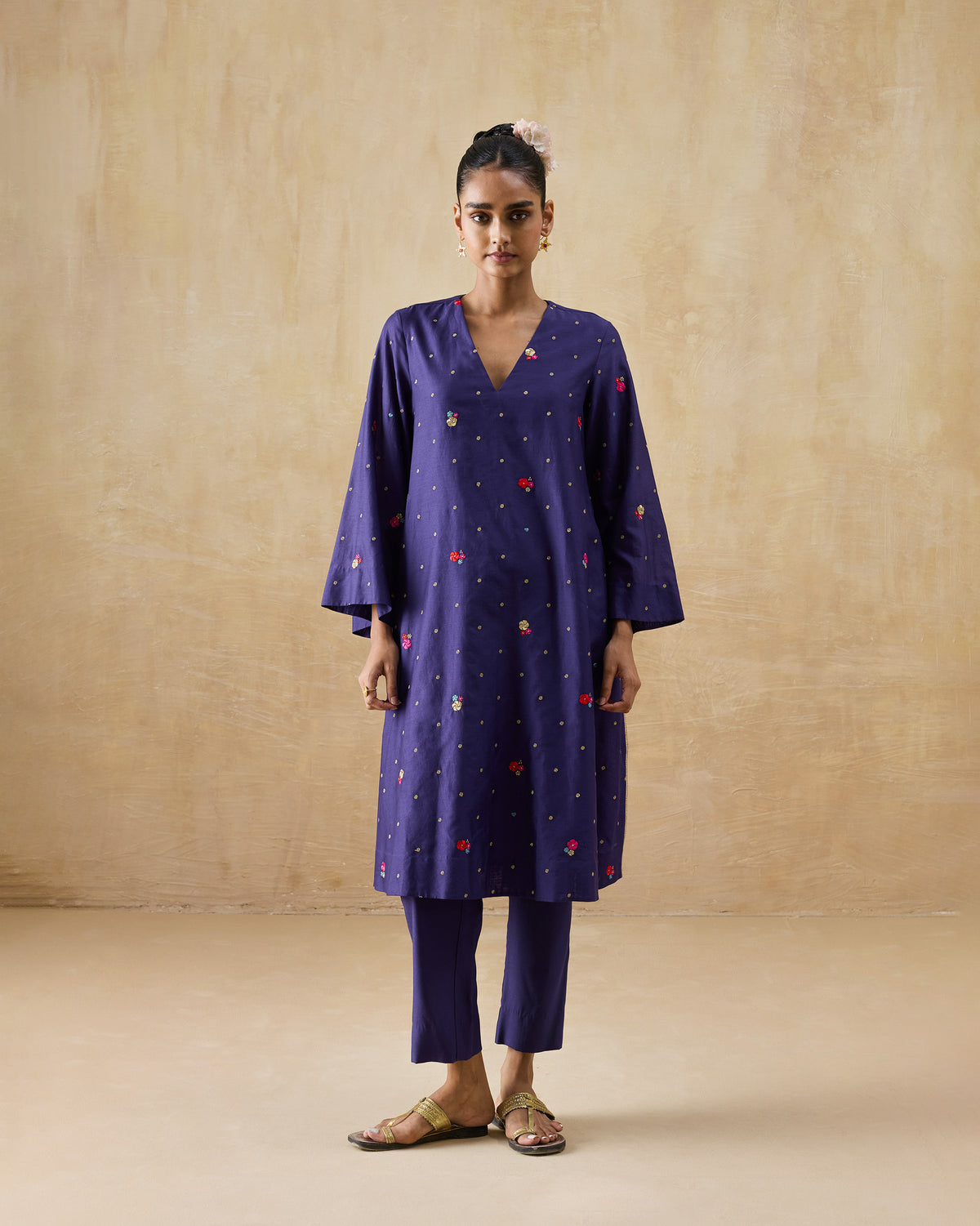 Person wearing a purple Nebula Kurta Set with gold dots and floral motifs.