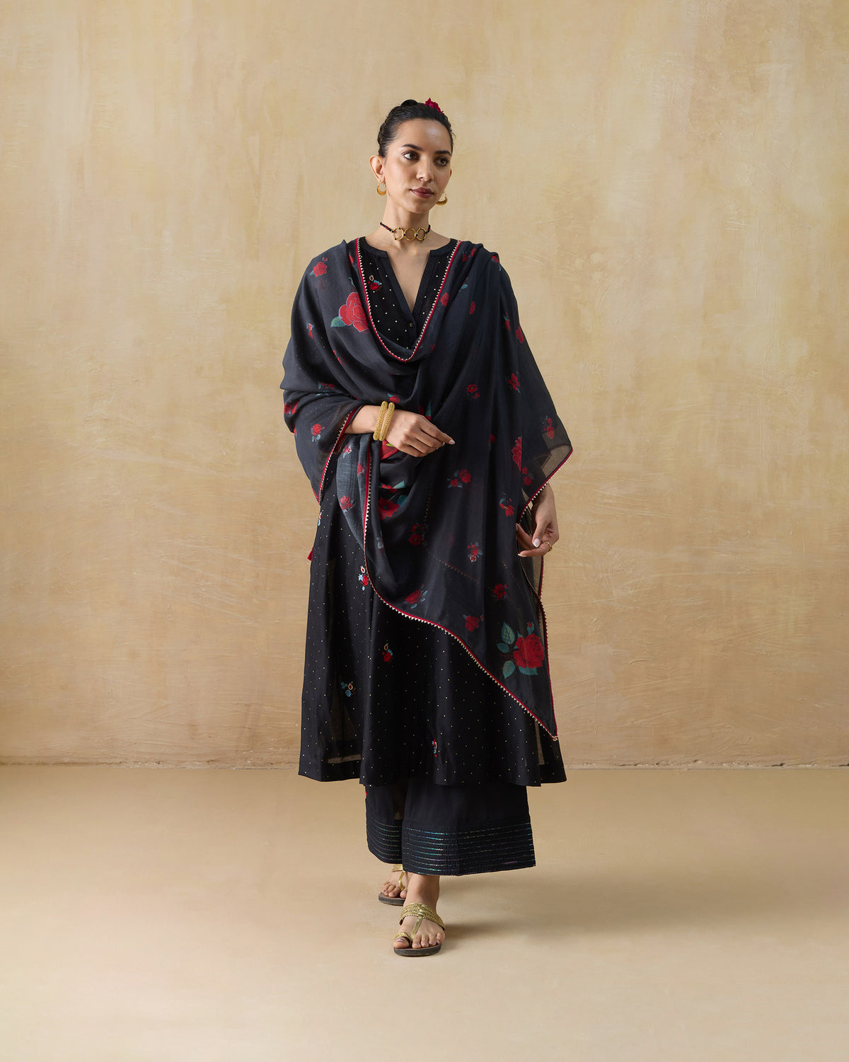 Black Moonbeam kurta set worn with a draped red rose-print dupatta.