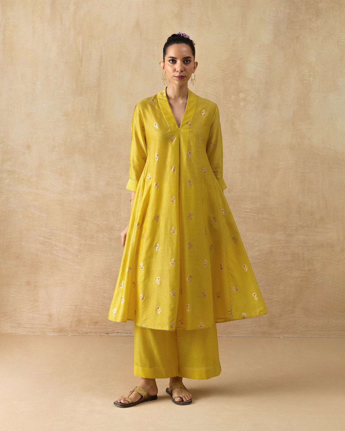 Person wearing a chartreuse Viva Kurta Set with floral motifs and wide pants.