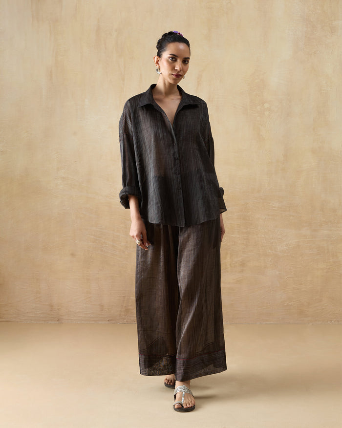 Person wearing the Firefly Shirt Set in dark charcoal with a relaxed shirt and wide trousers.