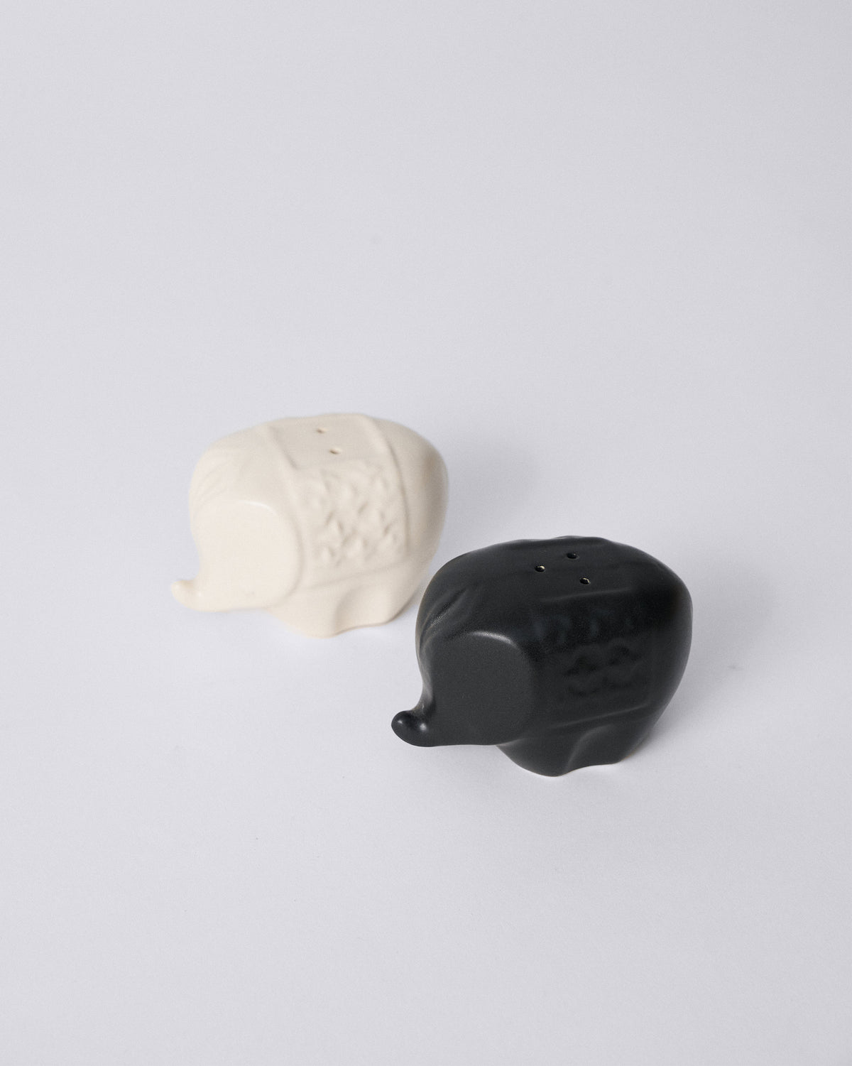 Black and cream Hathi elephant shakers with textured saddles.