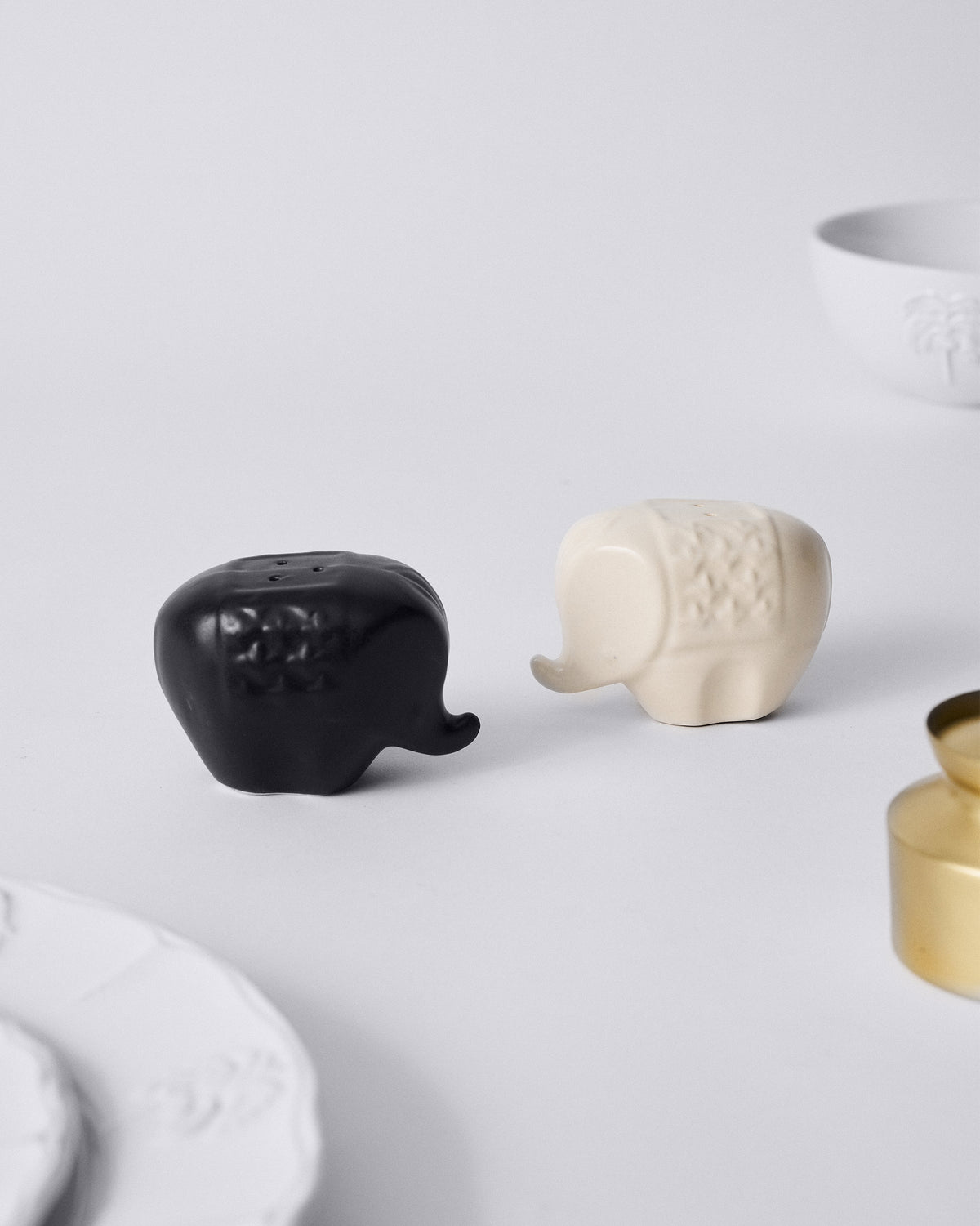 Hathi elephant salt and pepper shakers facing each other on a table.