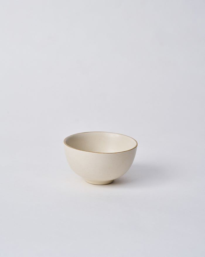 Tara Katori, a small cream bowl with a thin brown rim.