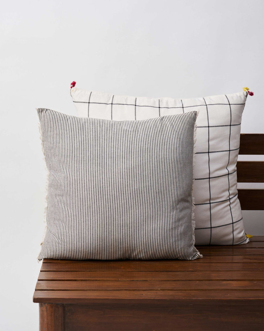 The pinstriped back of the cushion cover.