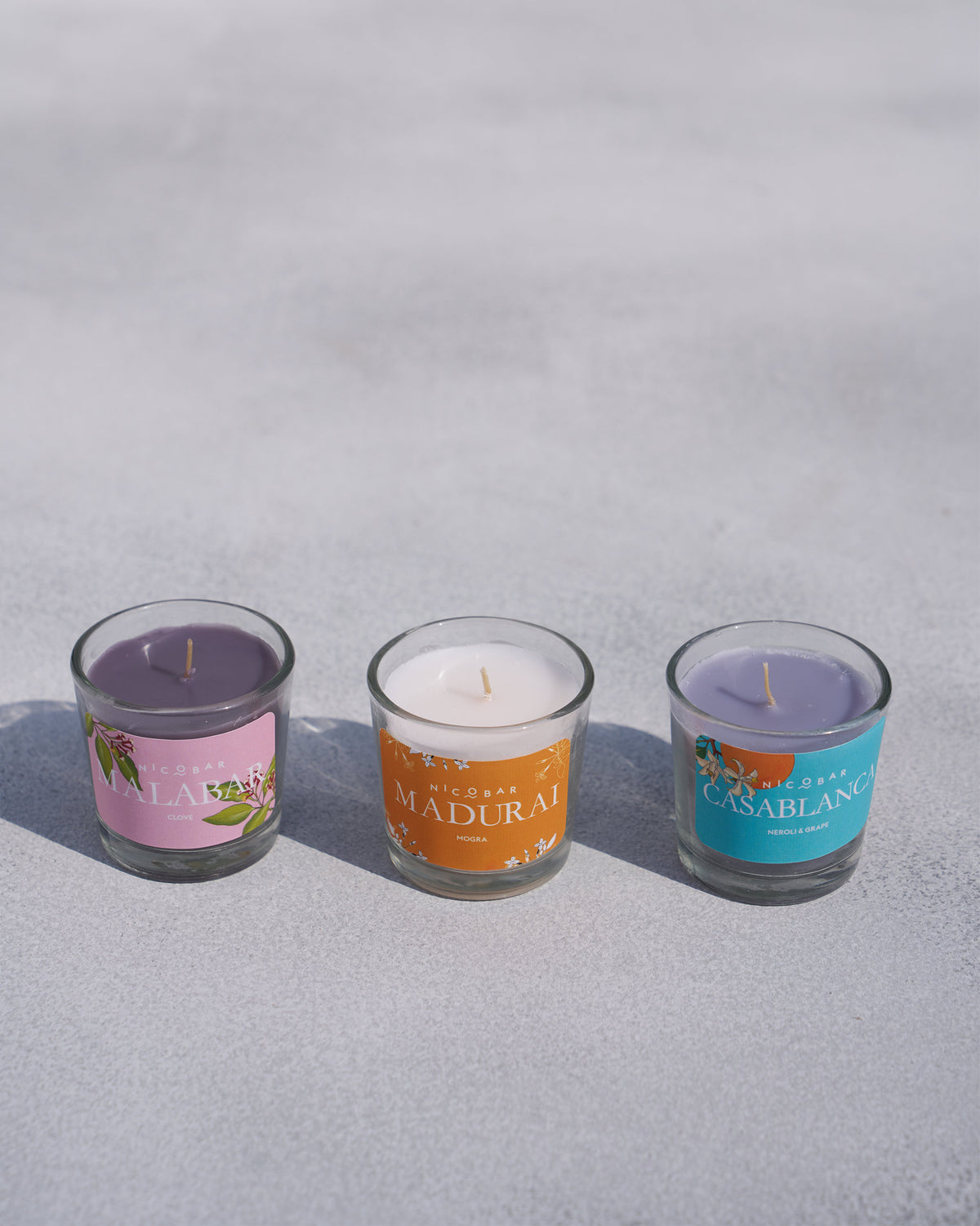 Malabar, Madurai, and Casablanca Trio Candle votives lined up unlit.