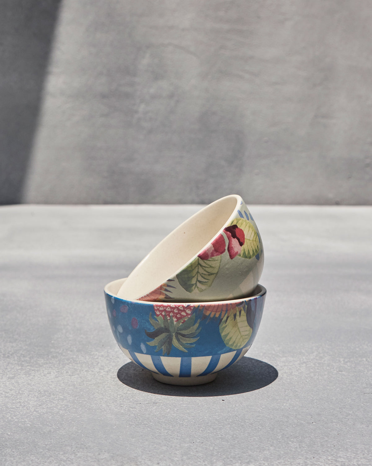 Mahi nibble bowls stacked, a blue bowl below a pale grey-green one.
