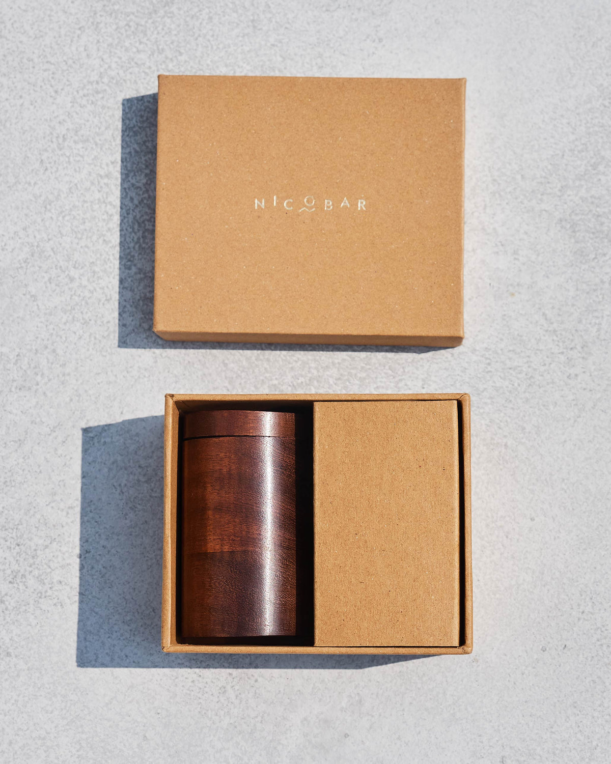 Dark wooden Nico Ludo dice case inside an open Nicobar gift box.