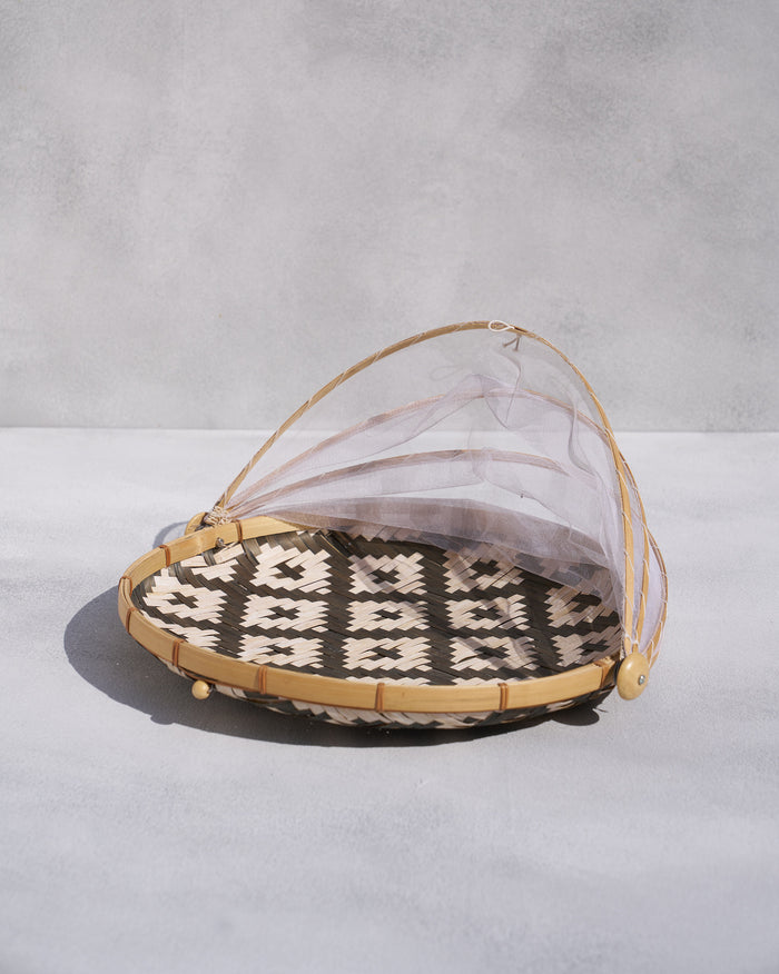 Alpine food cover with a bamboo tray, mesh dome and geometric weave.