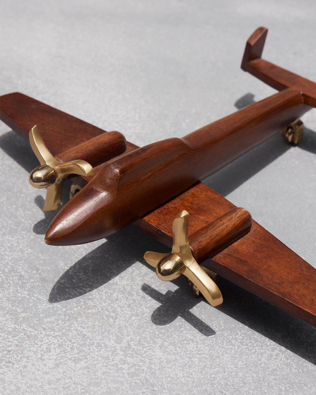 Close-up of Beufort airplane showing a brass propeller and wooden nose.