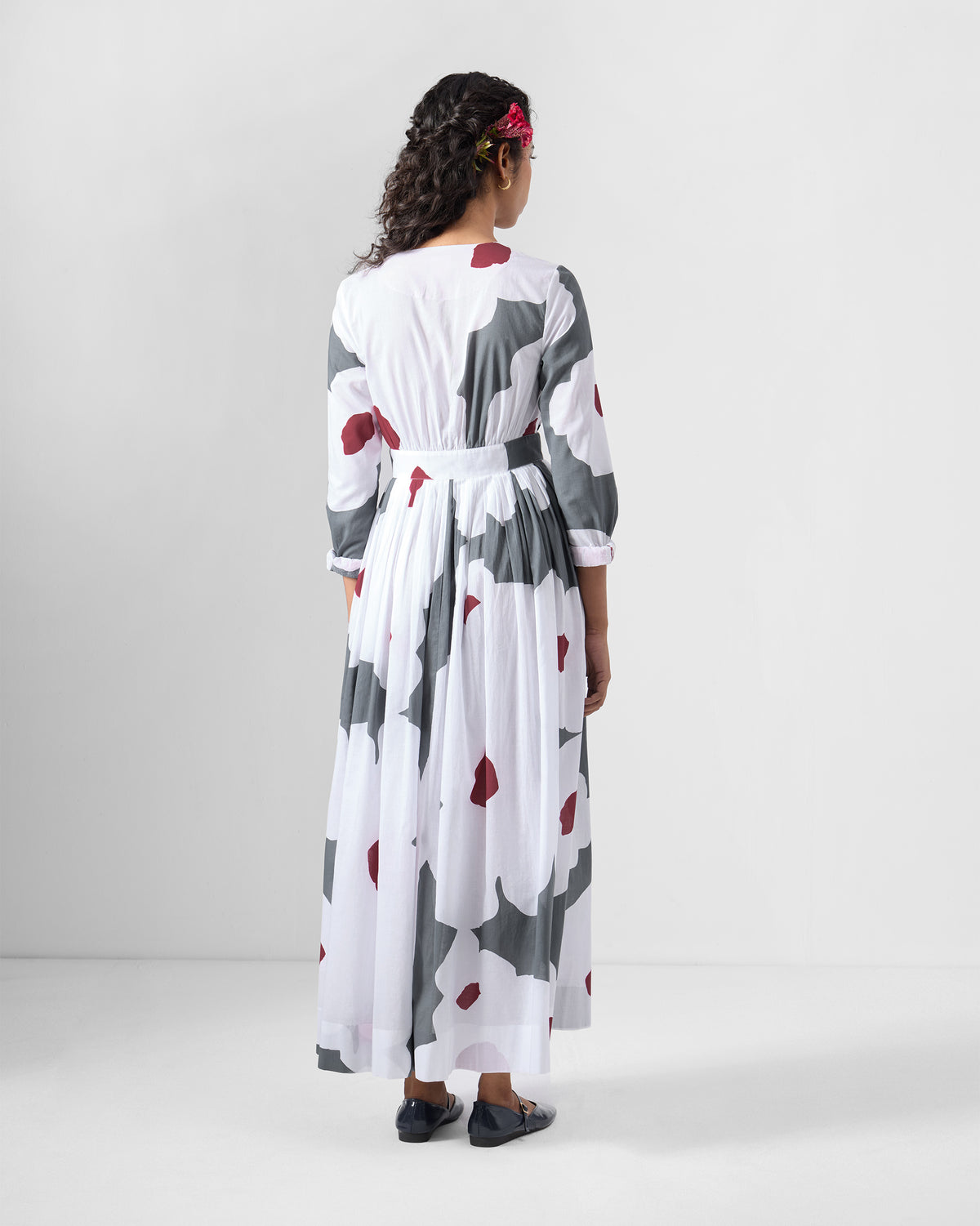 Back of a white Nico wrap dress with a gathered maxi skirt.