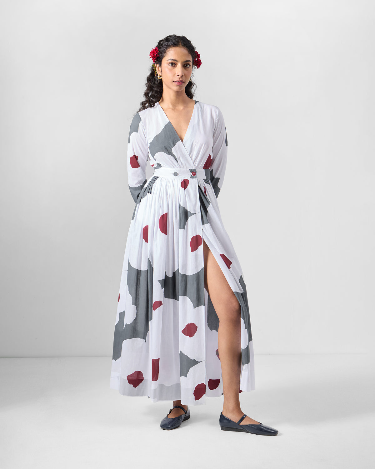 Person wearing a white Nico wrap dress showing a side slit in the skirt.