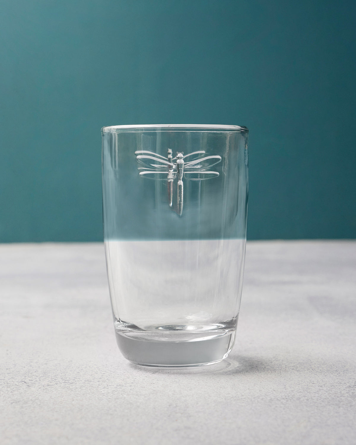 Clear Mahi long drink glass with a white dragonfly motif near the rim.