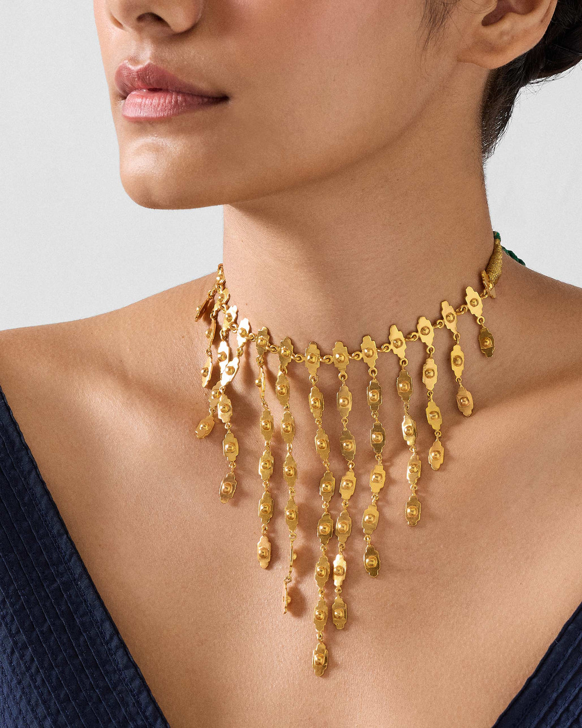 Gold zedi necklace with a graduated fringe worn as a choker.
