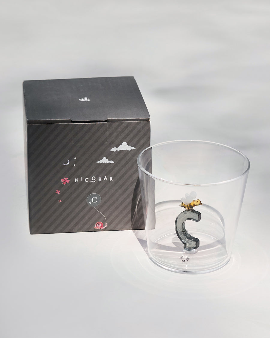 The glass beside its gift box.