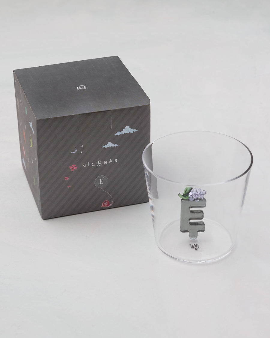 The glass beside its gift box.