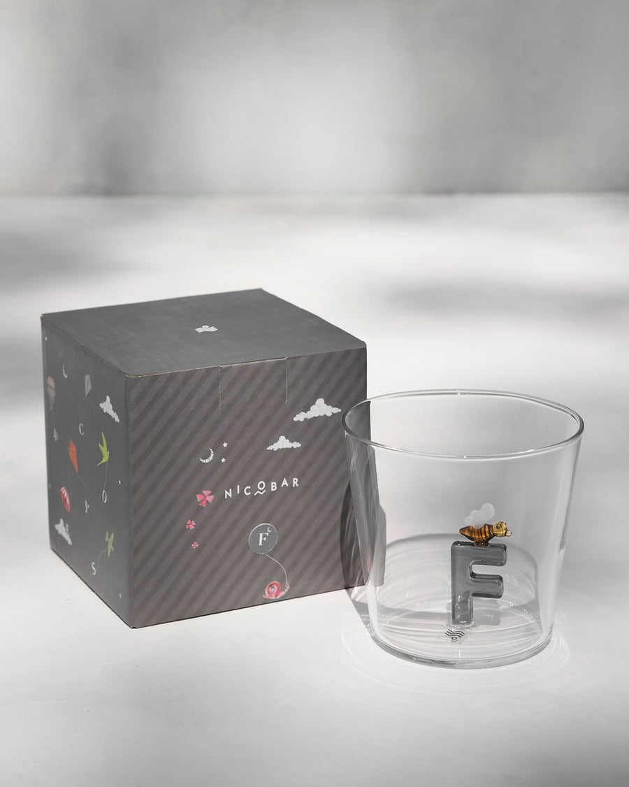 The glass beside its gift box.