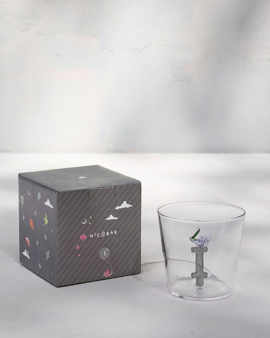 The glass beside its gift box.