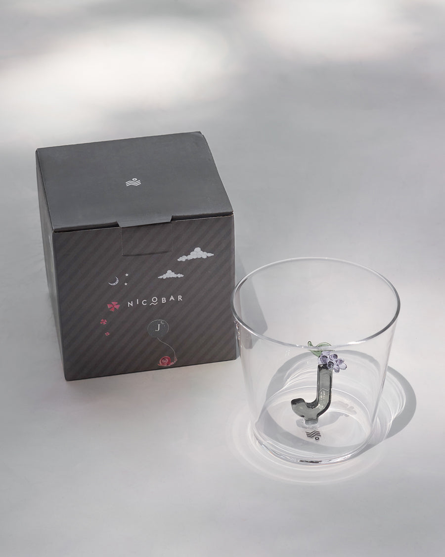 The glass beside its gift box.