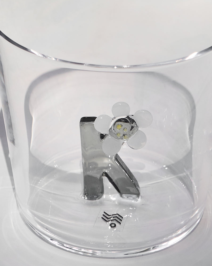 The glass beside its gift box.