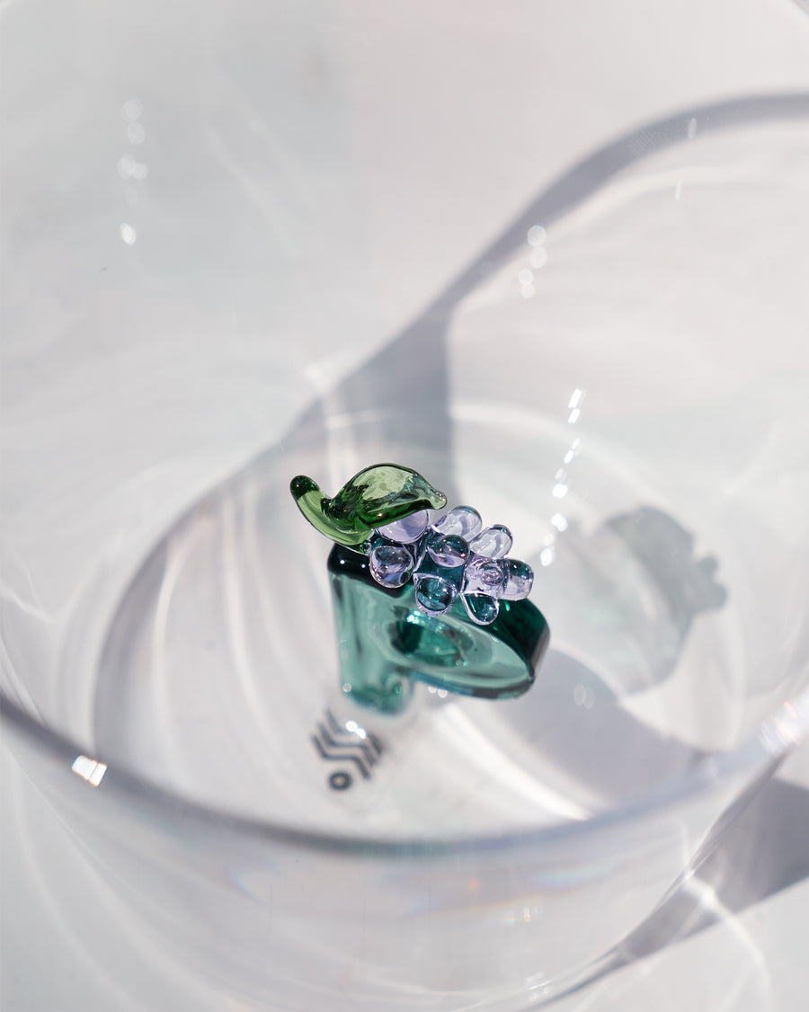 The glass beside its gift box.