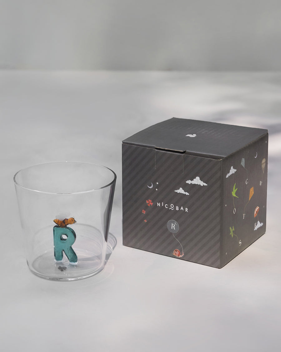 The glass beside its gift box.