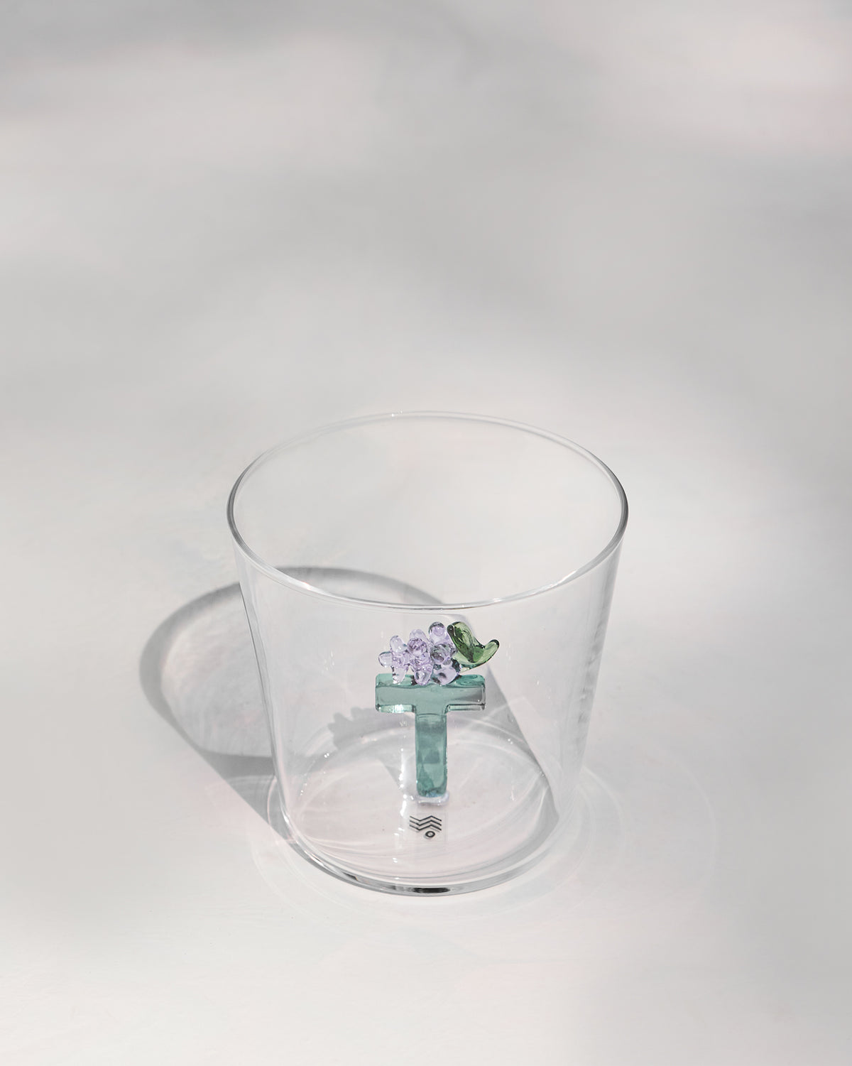 The letter T inside the glass.