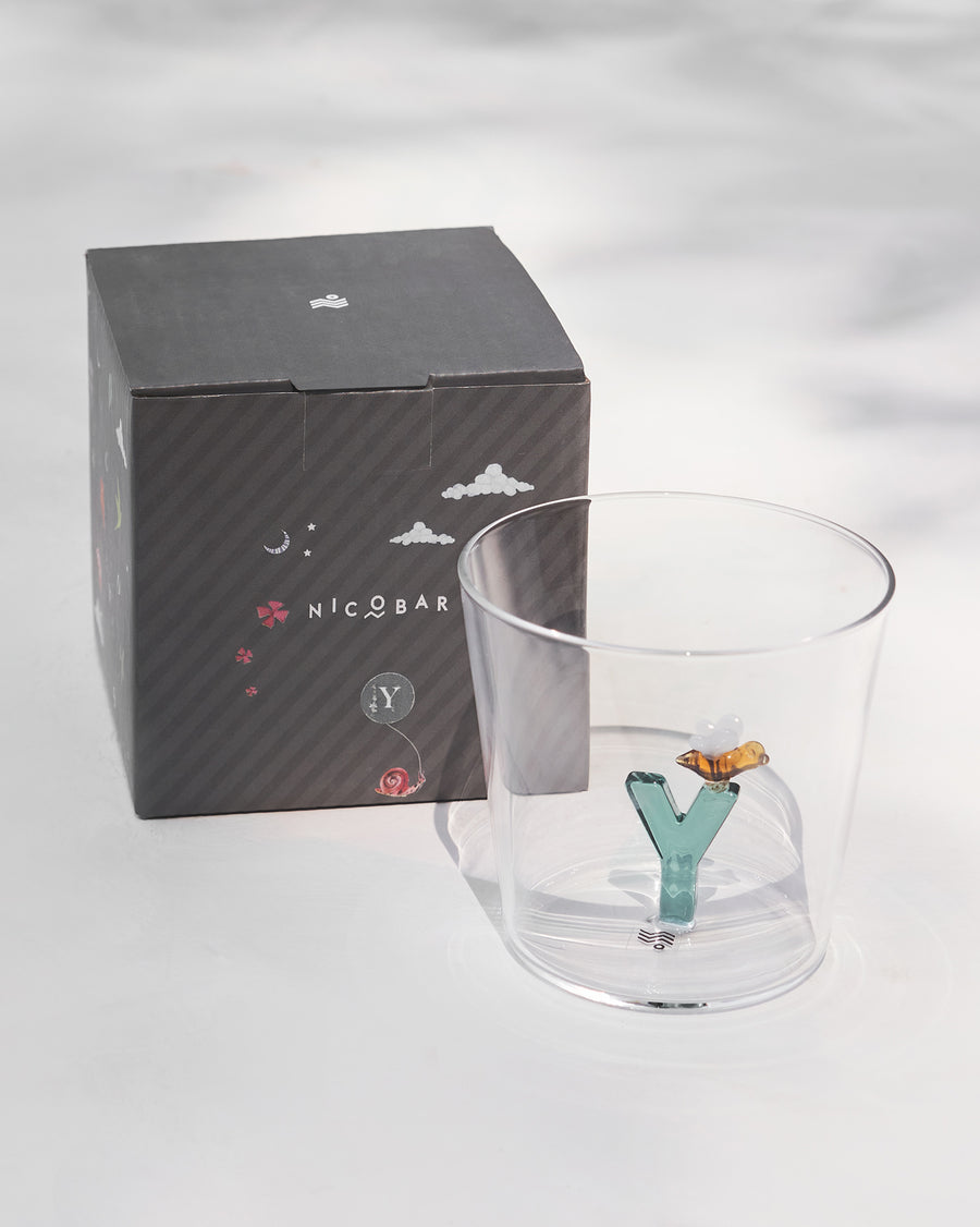 The glass beside its gift box.