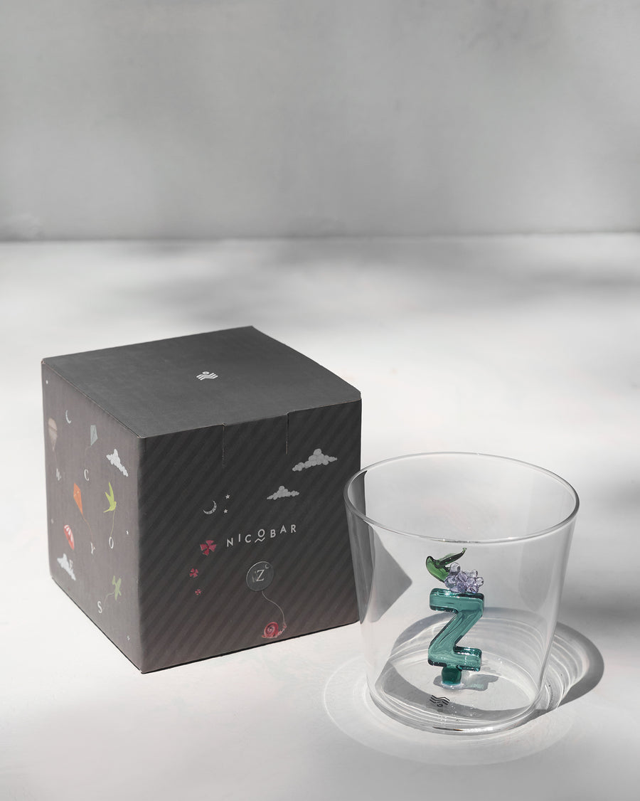 The glass beside its gift box.