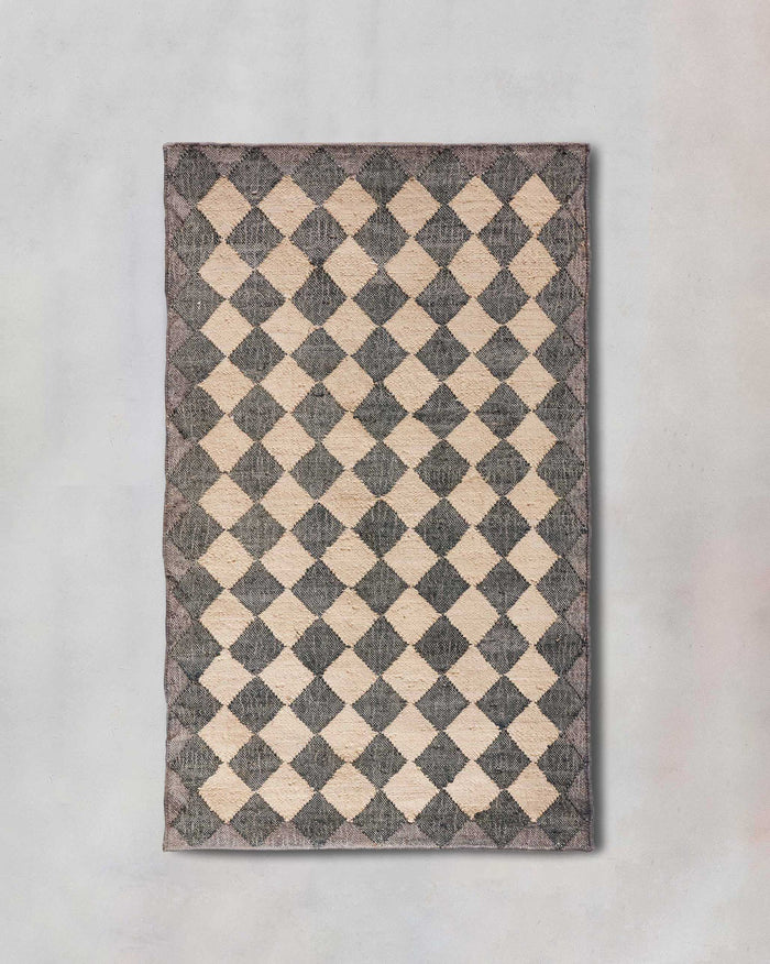 Fez Rug with a charcoal and cream diamond checkerboard pattern.
