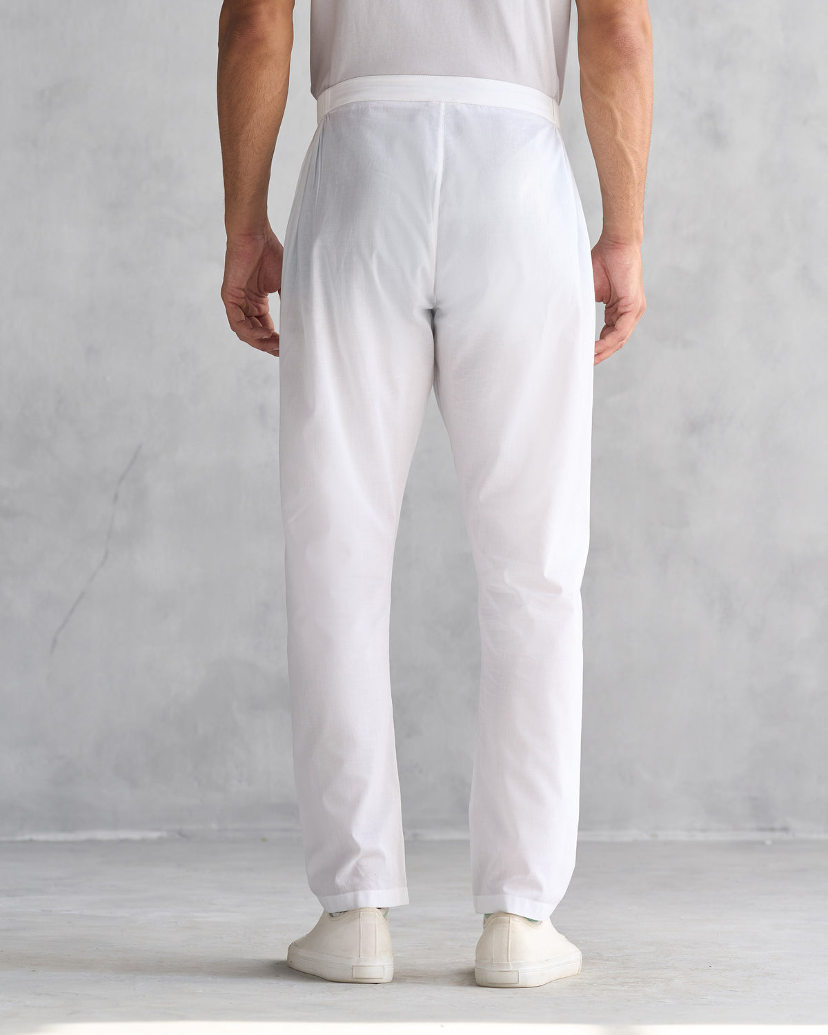 Back of white Kurta Pants worn by a person.
