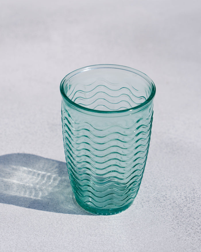 Aqua tumbler with a wavy textured glass body.