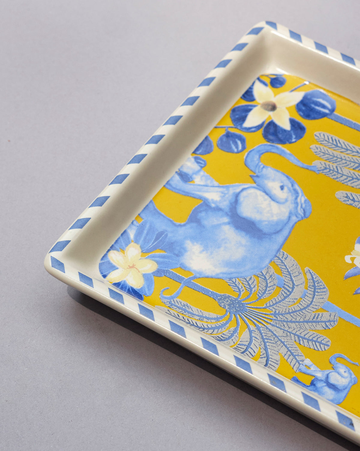 Close-up of the Alam Cookie Tray showing its blue elephant and palm print.
