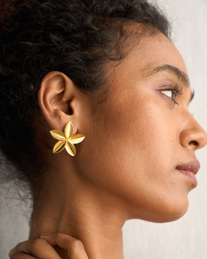 Side profile of gold Frangi Studs worn on a person.