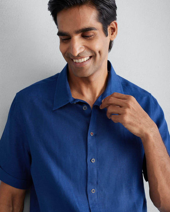 Person wearing a navy Half Sleeve Shirt with a classic collar.