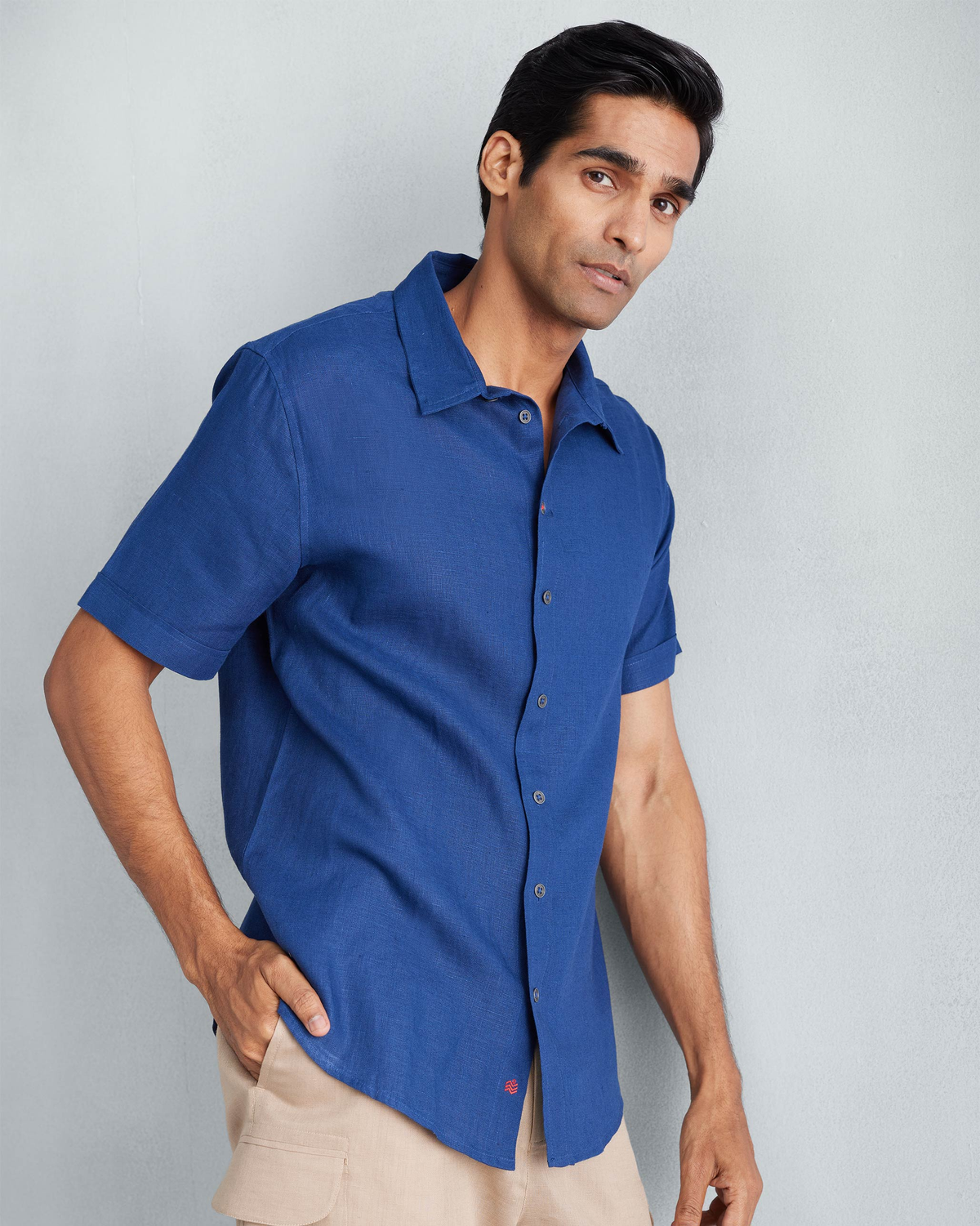 Person wearing a navy Half Sleeve Shirt with a classic collar.
