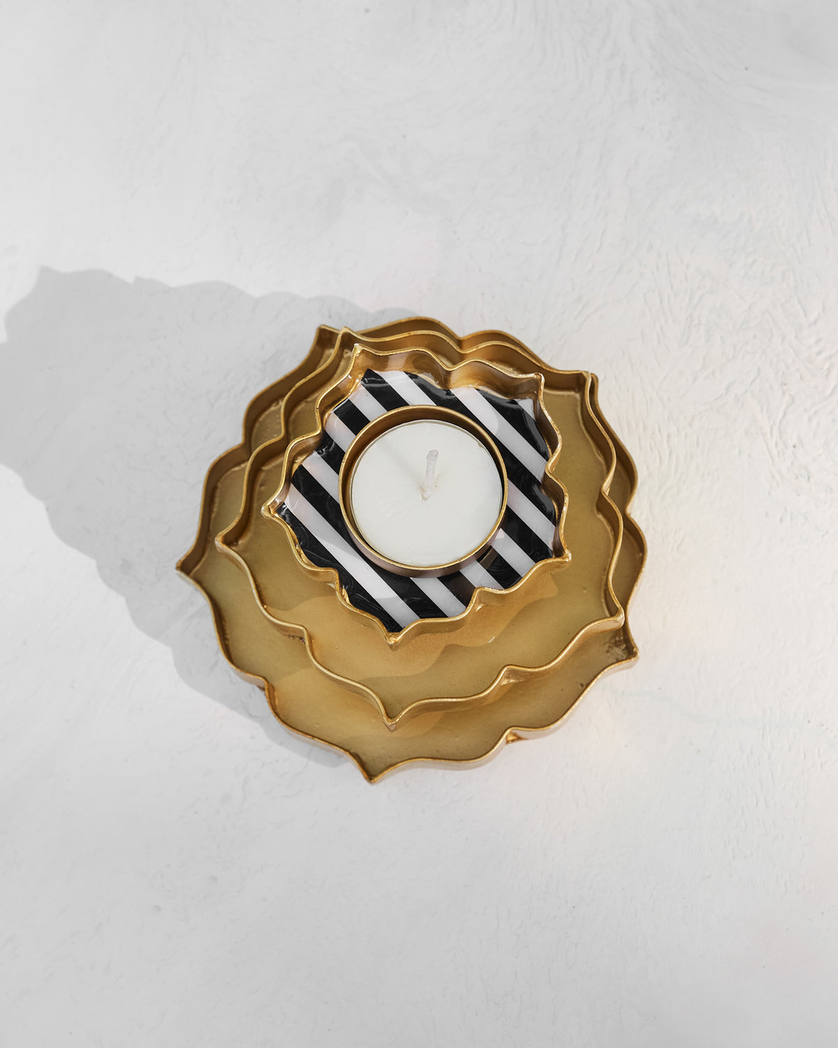 Overhead view of a Sama votive with black and white striped center.