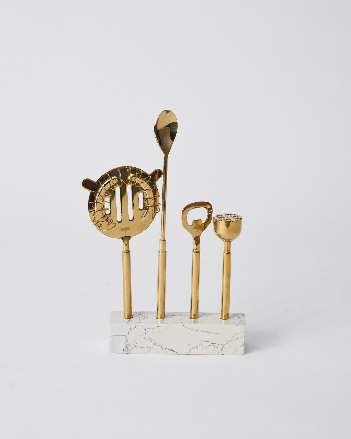 Aurum Bar Tools standing upright on a marble base.