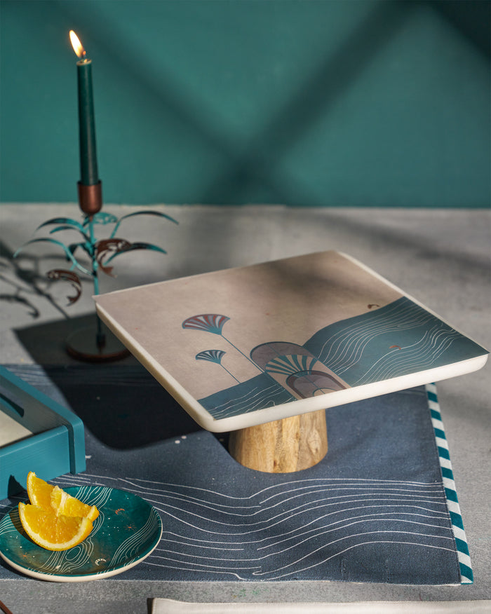 Cake stand with a fan and wave print on its top.