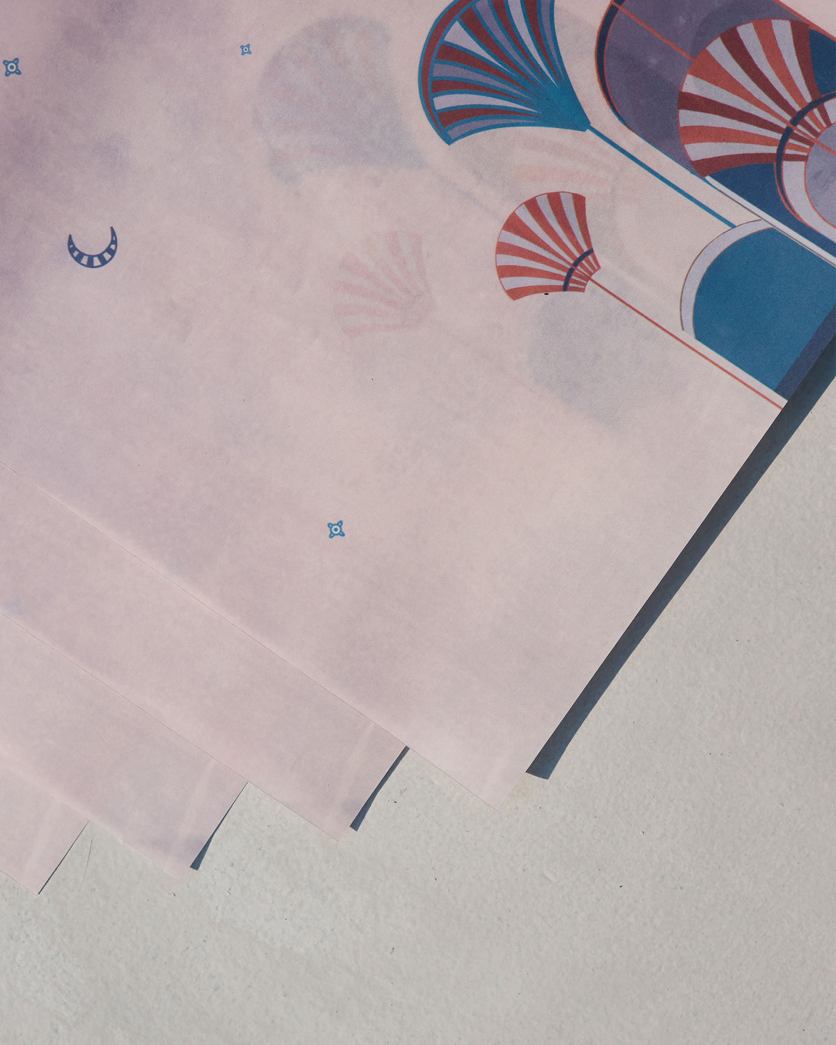 Close-up of Tranquil Parchment Paper Rectangle sheets showing fan and crescent motifs.