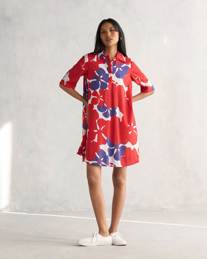 Person wearing a multi-colour Happy Heart Dress with red hibiscus print.