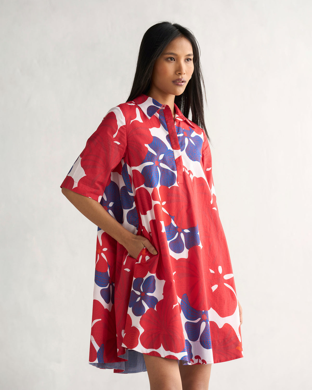Multi-colour Happy Heart Dress flaring to show a pocket and striped lining.