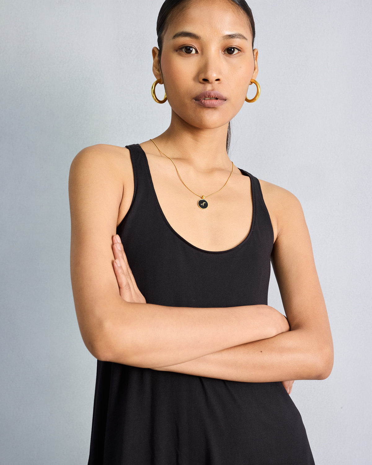 Close-up of the scoop neckline on a black Esther dress.