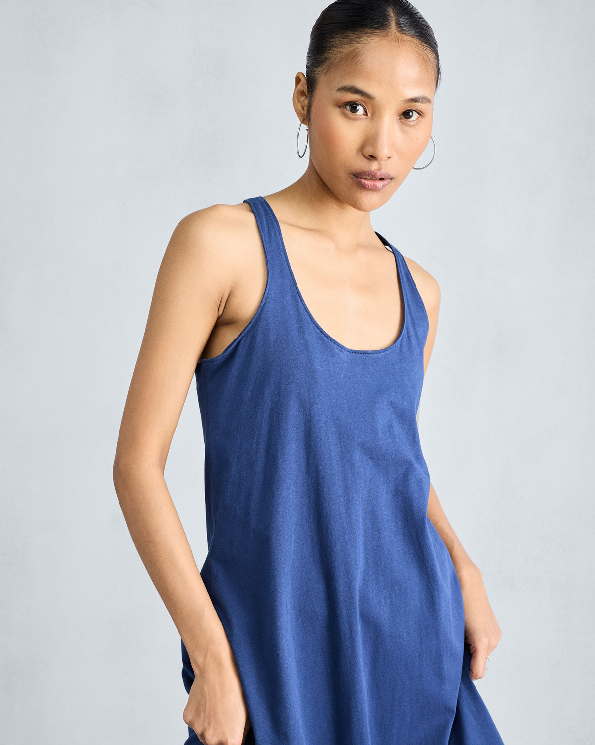 Close-up of the scoop neckline on a navy Esther dress.